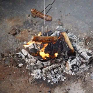 Cooking sausages on a fire pit