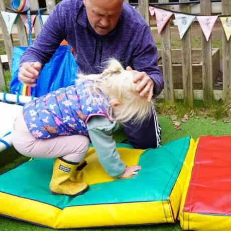 Nursery child learning to roll forward